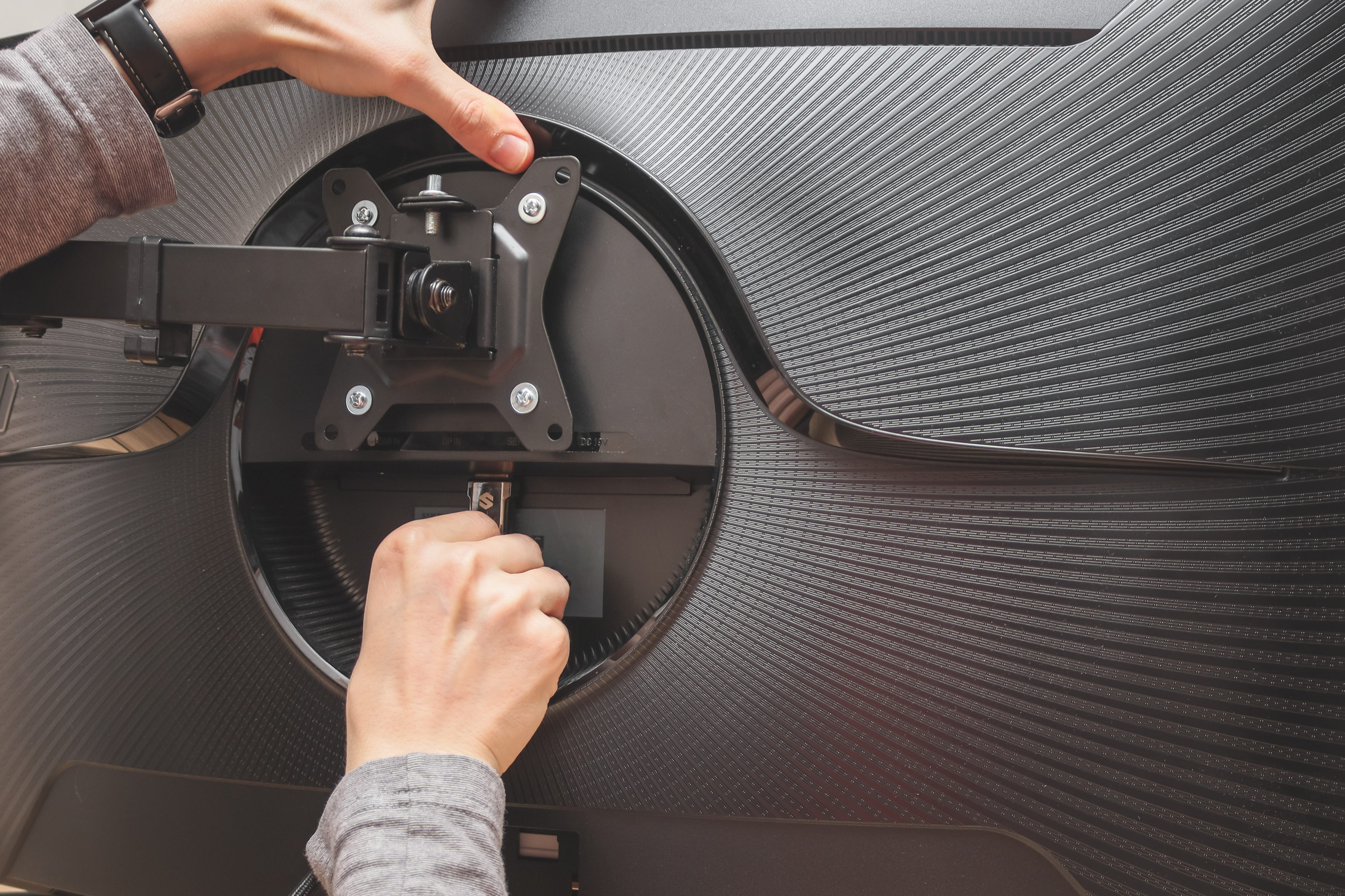 Rapid TV Mounting technician fitting a VESA bracket — premium TV installation in Gauteng